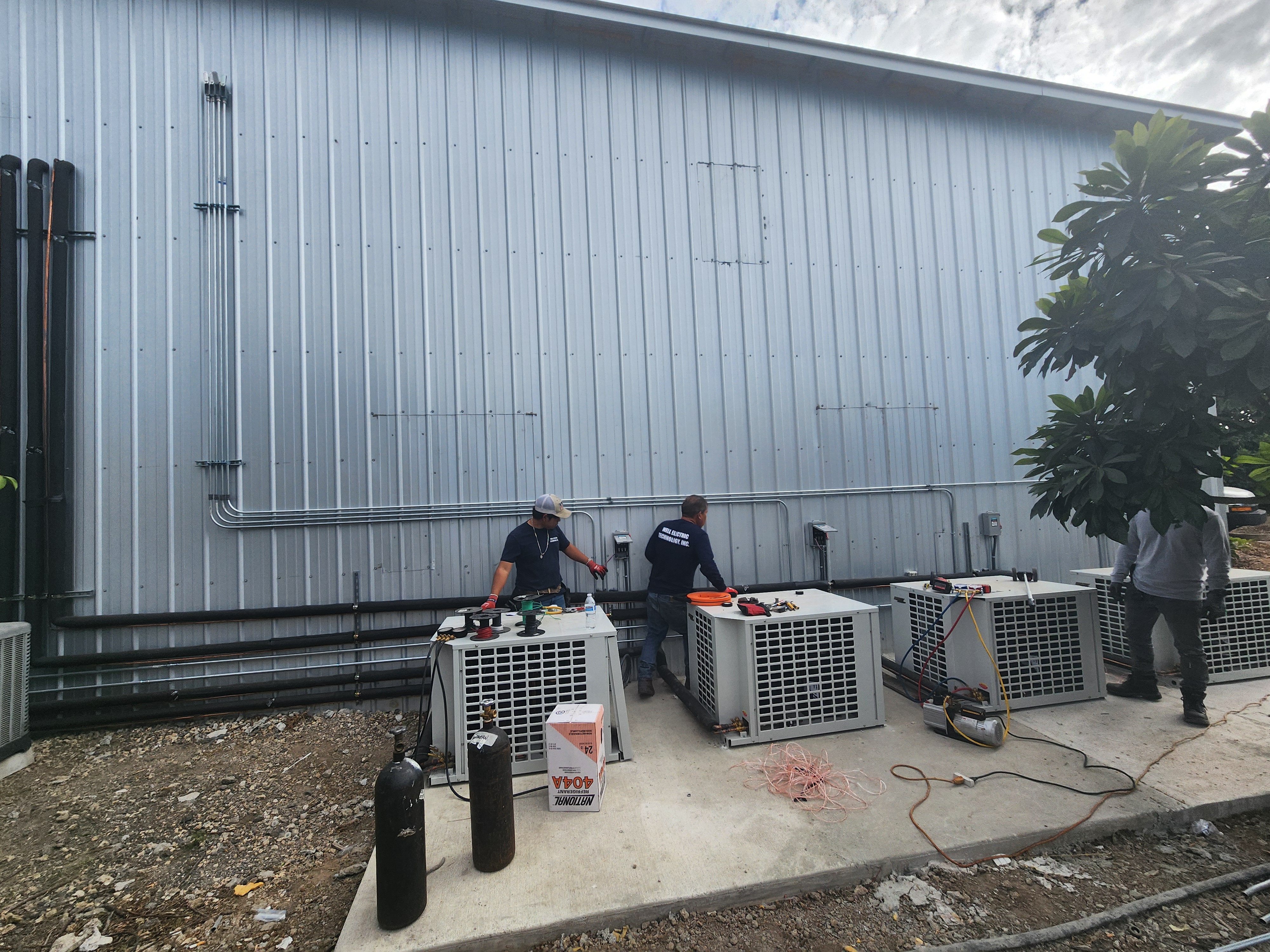 Advance Tech Electric crew installing conduit and equipment